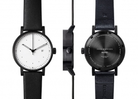 与爱立信合作开发的现代简约限量版V03D-Dezeen手表设计。最小的刻度盘的图形，一个黑色的外壳和黑色真皮表带，反映虚空手表和回美感