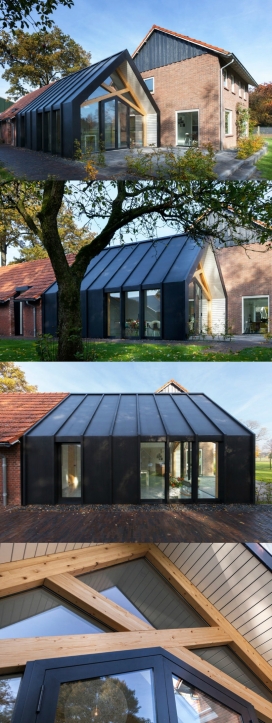 荷兰-50年代的黑色农舍建筑设计-加入了许多现代延伸元素，典型是延伸到旧谷仓，开辟了花园