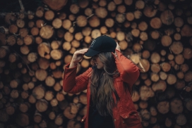 木材堆戴帽子的女子