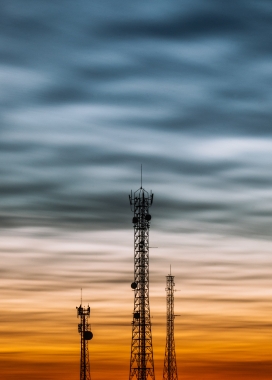 夕阳下的高压线信号塔图片